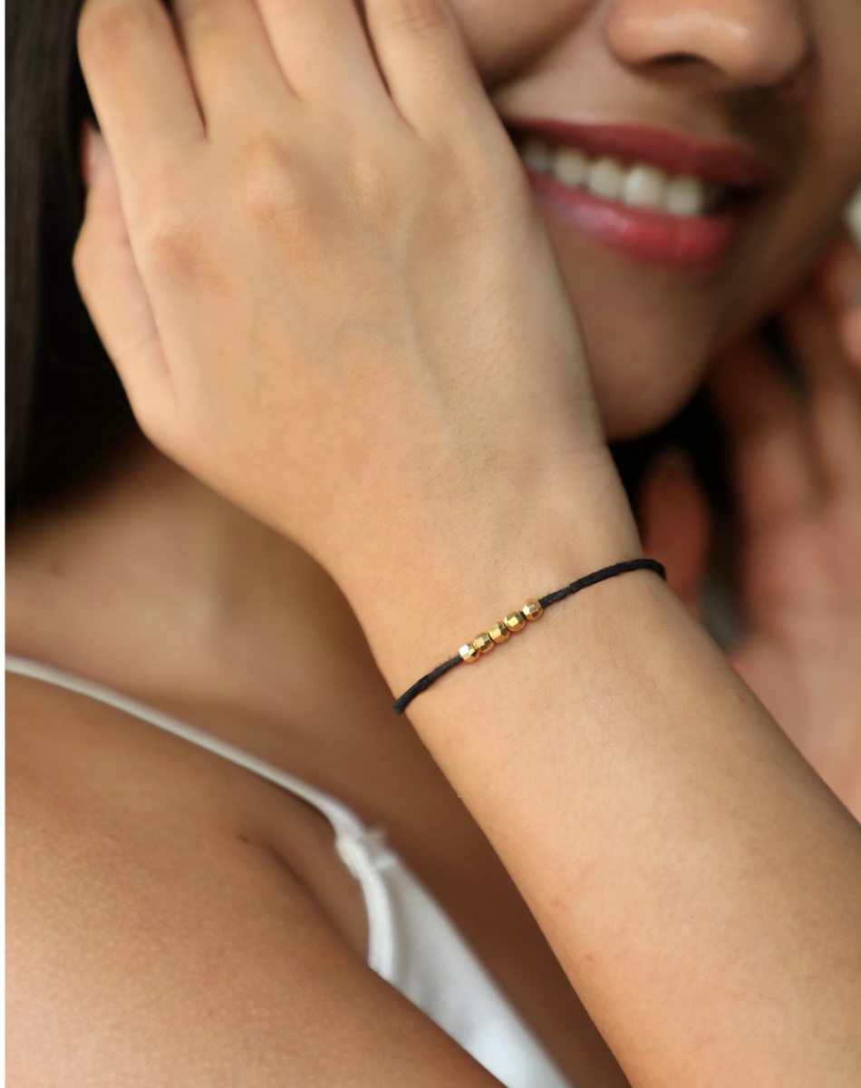 Black beads and gold bracelet discount
